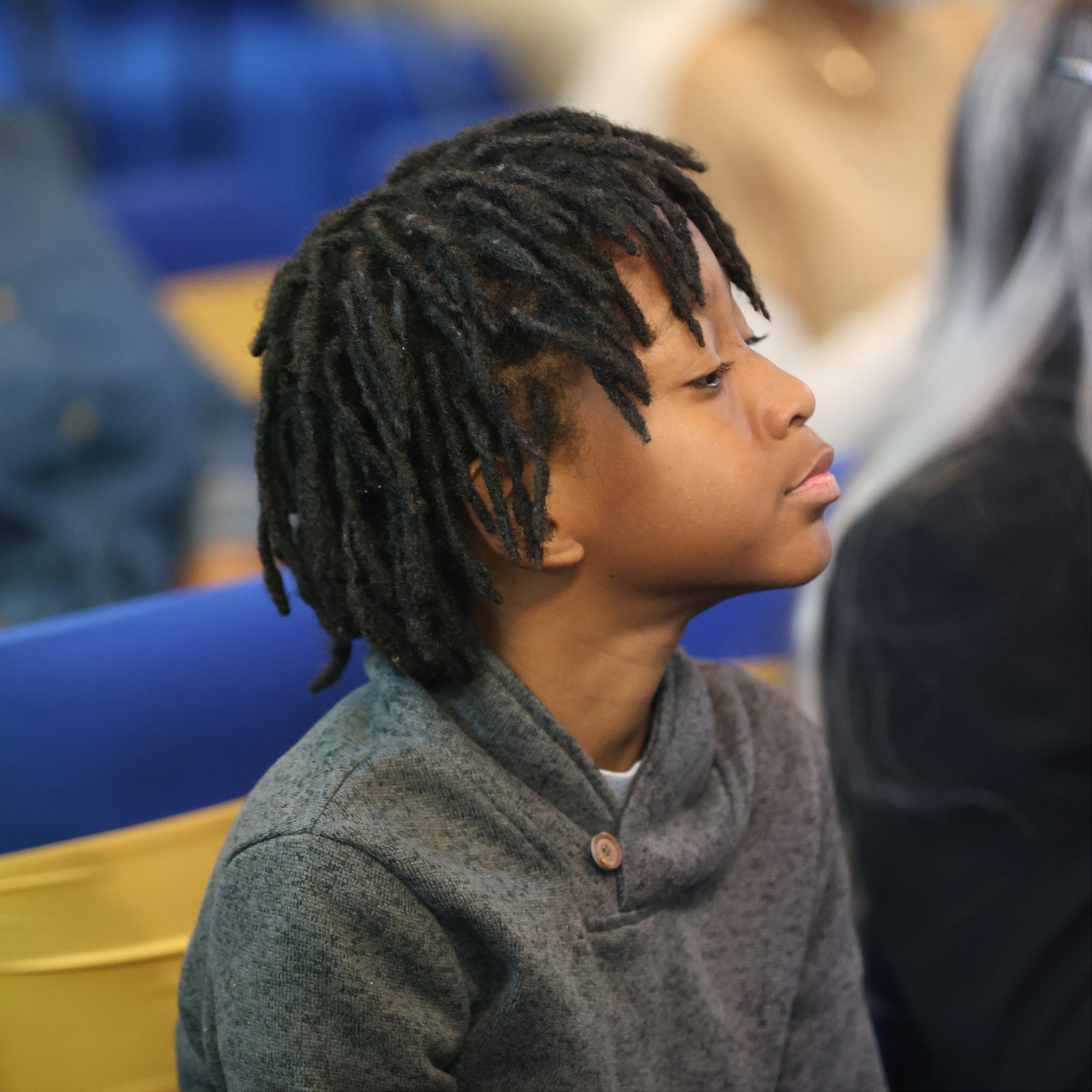 child looking up at the church speaker